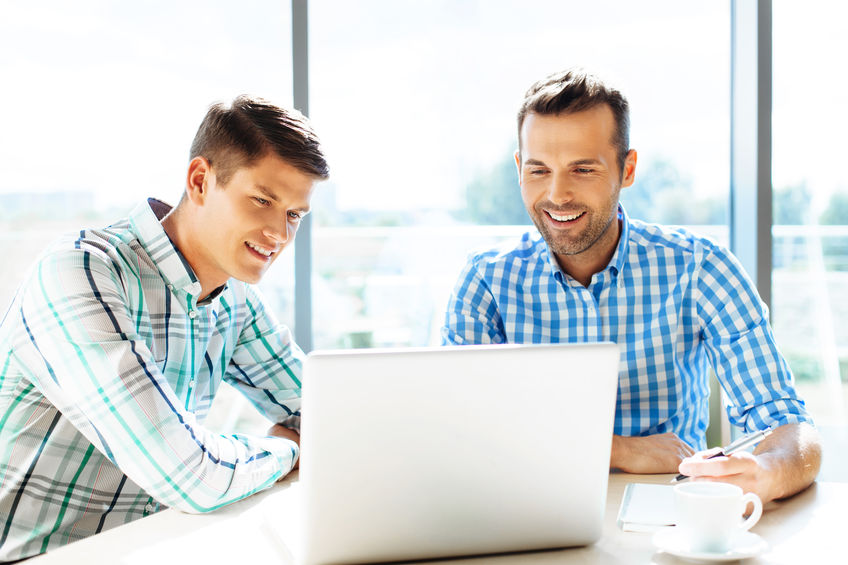 Two Males By a Computer